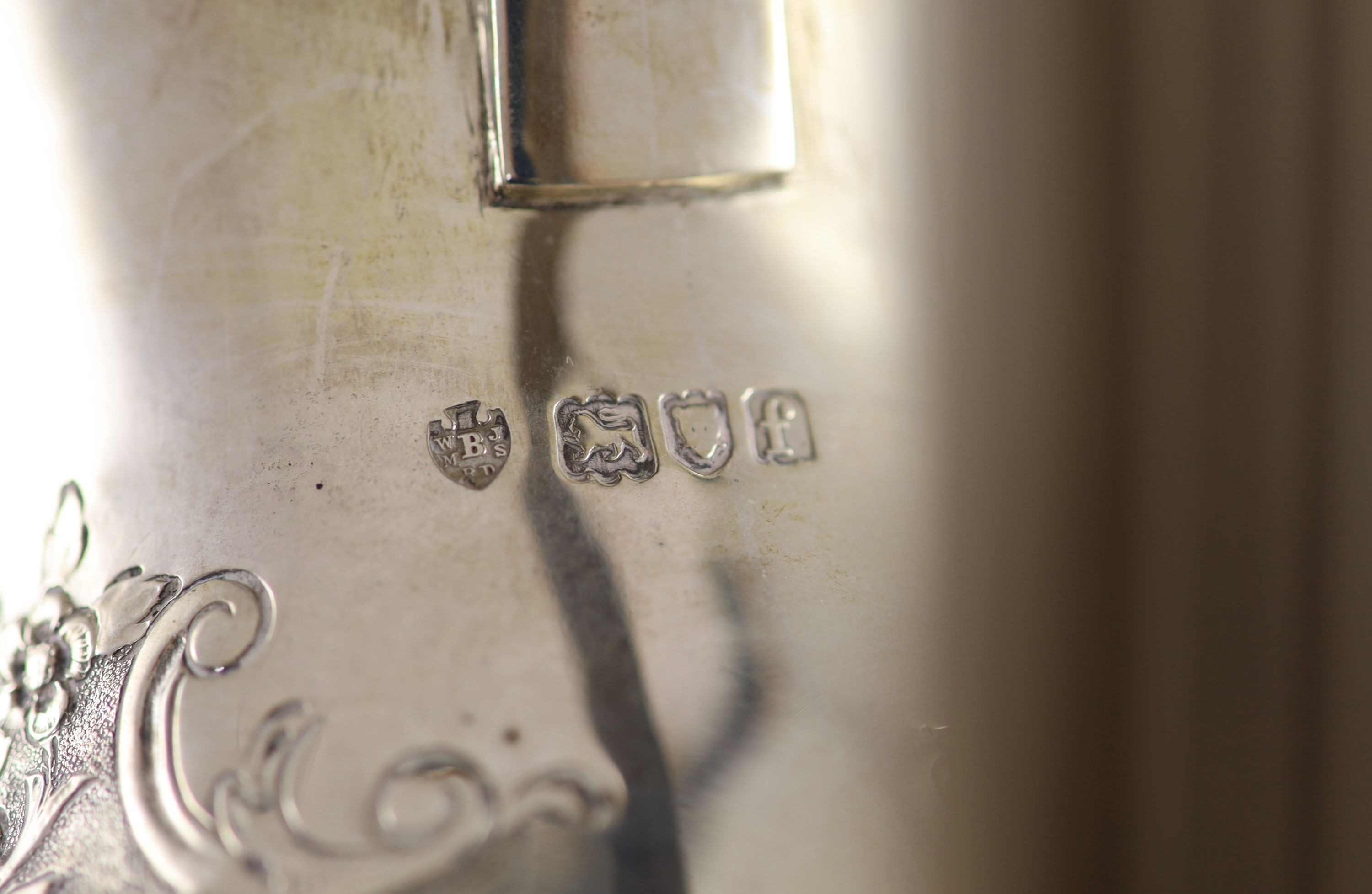 An Edwardian embossed silver circular four piece tea and coffee service by Edward Barnard & Sons Ltd